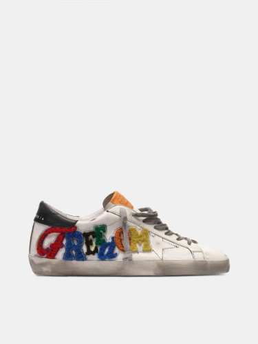 White Superstar sneakers with multicoloured patch