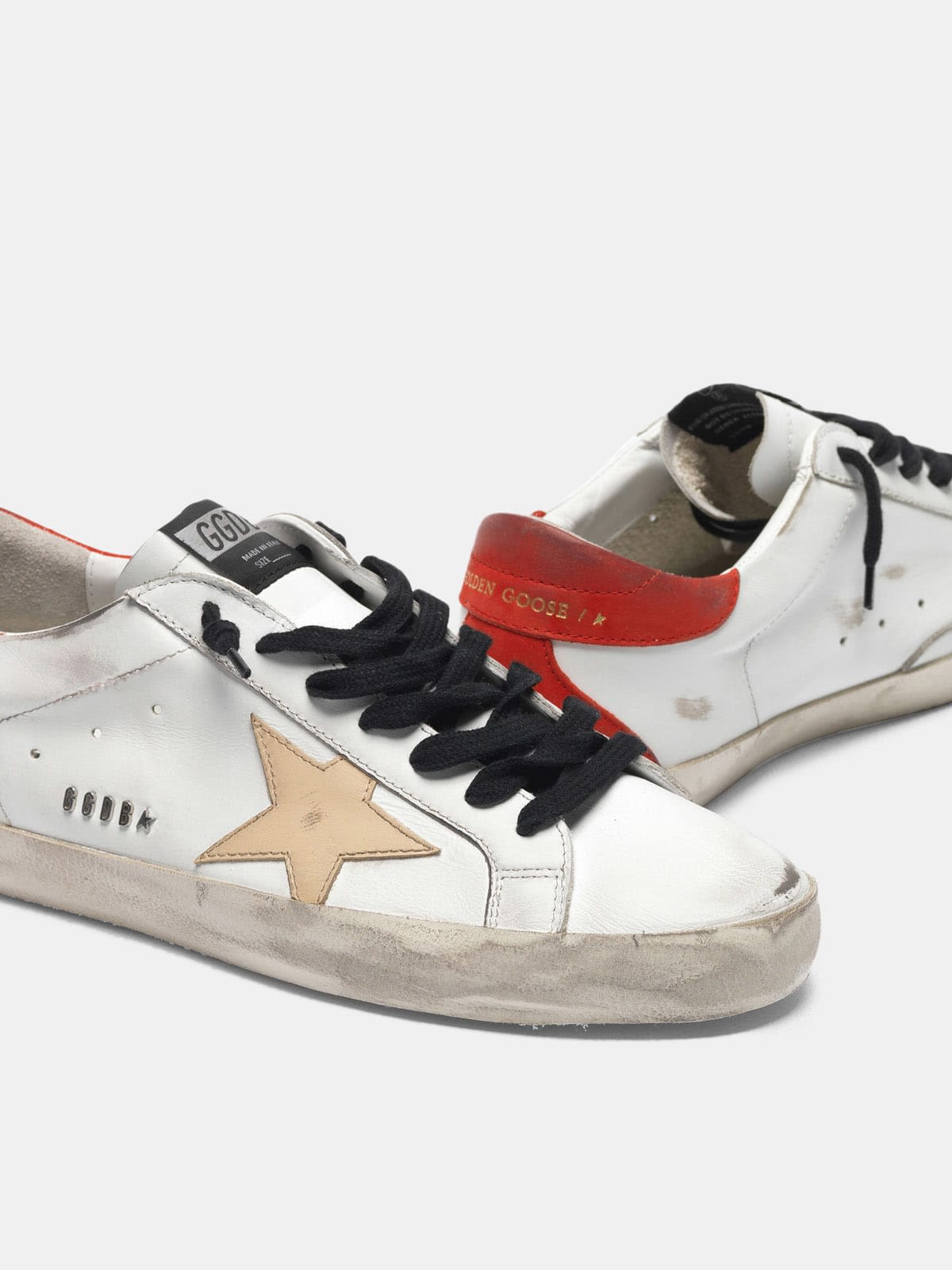 White Super-Star sneakers with red rear and black laces