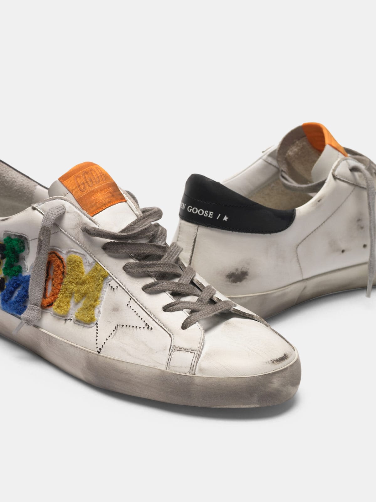 White Superstar sneakers with multicoloured patch