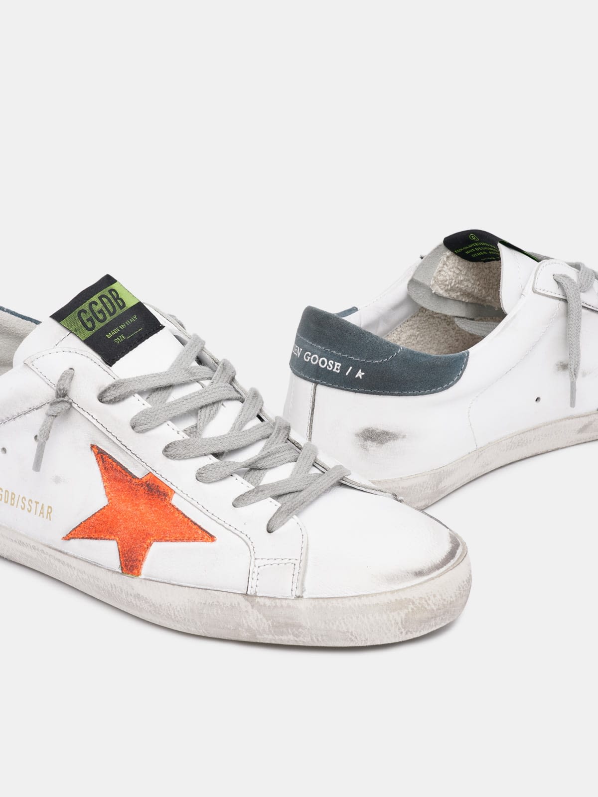 White Super-Star sneakers with orange star